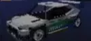 White Ocelot R1 rally car with blue and green graphics and a rear wing.
